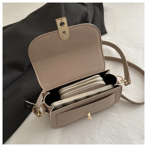 Interior view of beige crossbody bag showing space for a phone and zipper wallet