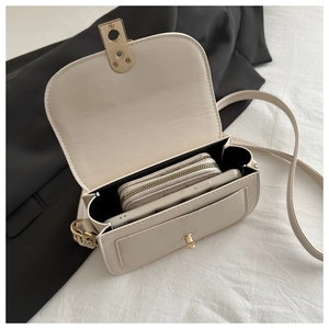 Interior view of cream shoulder bag showing phone storage and zipper compartment