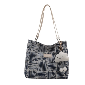 Minimalist canvas tote bag with geometric patterns and a plush cloud charm accessory
