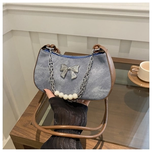 Retro denim dumpling bag with silver bow detail, pearl chain and brown leather strap