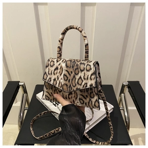 Detail of leopard print faux fur crossbody bag with top handle and magnetic closure