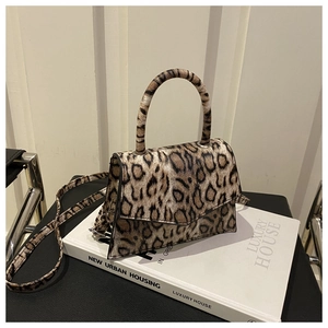 Detail of leopard print handbag with magnetic closure and detachable shoulder strap