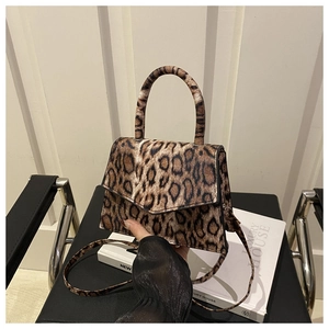 Close-up of leopard print handbag with magnetic closure and matte textured finish