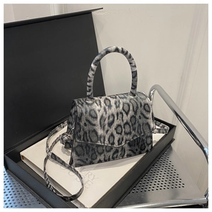 Detail of leopard print handbag with magnetic closure and detachable shoulder strap