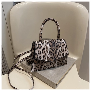 Detail of leopard print handbag with magnetic closure and soft textured faux fur finish