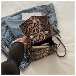 Detailed interior of leopard print handbag showing magnetic buckle and daily storage capacity