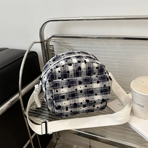 Chic black and white checkered crossbody bag with heart pattern and wide strap