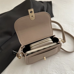 Chic beige crossbody bag showing interior capacity for a wallet and smartphone