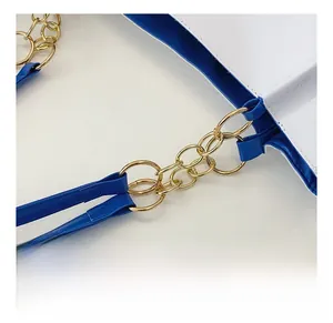 Detail of premium gold-tone metal chain link on a blue and white leather tote bag