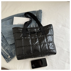 Chic black quilted puffer tote bag in glossy nylon fabric with wide webbing handles