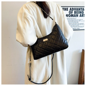 Classic black quilted tote bag with gold hardware and chain strap shown on model