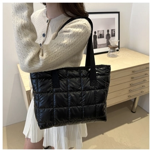 Lifestyle view of a black quilted tote bag with large capacity for autumn casual wear
