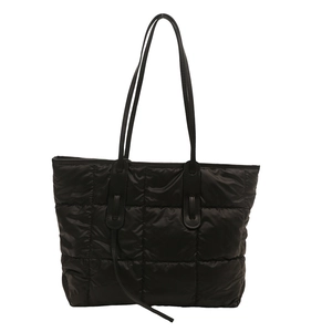 Large black quilted tote bag for women with leather straps and minimalist modern design