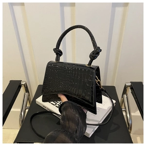 Detail of black crocodile pattern PU leather crossbody bag with unique knot handle