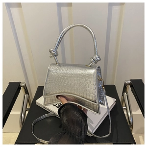Silver crocodile texture handbag with decorative knotted handle and metallic finish detail