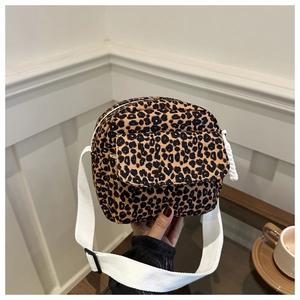 Handheld view of a trendy leopard print crossbody bag with a wide adjustable white strap