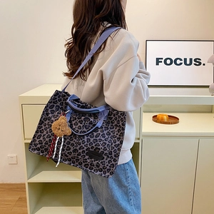 Leopard print canvas tote bag with dual straps and cute plush bear charm for daily use
