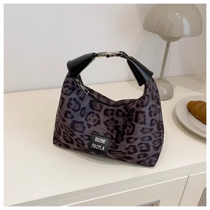 Détail d'un sac à main léopard avec poignée en cuir et boucle métallique vintage