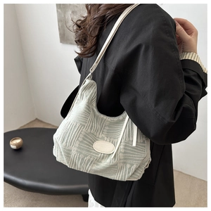 Detail of light green textured canvas tote with leather straps and Fashion Bags logo