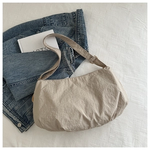 Detailed flat lay of beige hobo tote bag with soft texture on a clean background