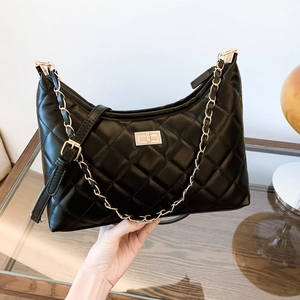Quilted black leather shoulder bag with gold chain strap and moon-shaped design