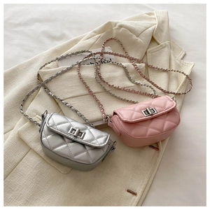 Detail of quilted leather texture and metal chain straps on silver and pink mini bags