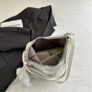 Large capacity light green shoulder bucket bag showing spacious interior with accessories