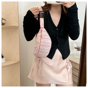 Detailed mirror selfie showing a pink striped fabric crescent crossbody bag for women