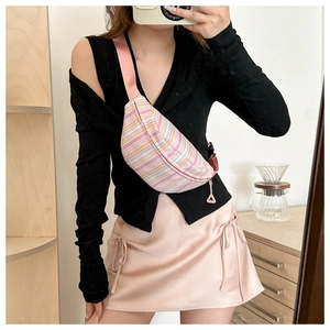 Mirror selfie showing a pink and yellow striped crossbody bag with adjustable strap
