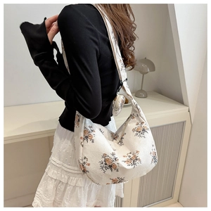 Detail of white corduroy crossbody bag with vintage floral print and round coin purse