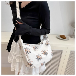 Detail of floral corduroy crossbody bag showing retro flower print and moon shape design