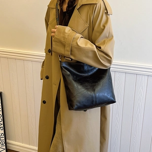 Minimalist black PU leather tote bag with vertical stitching for classic workwear style