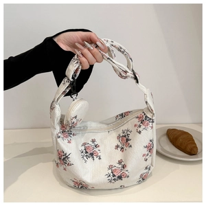 Detail of floral corduroy dumpling bag with matching round coin purse and metal zipper