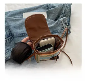 Detail view of woven phone bag interior showing space for a smartphone and wallet