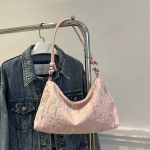 Pink crescent shoulder bag with colorful bead tassels and textured embossed patterns
