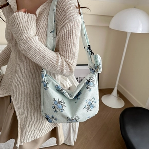 Floral corduroy dumpling bag with adjustable strap and small matching coin purse