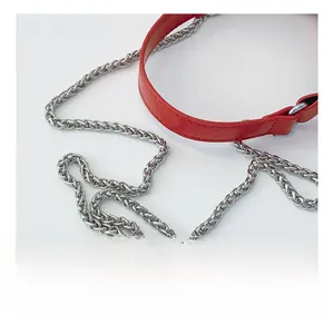 Detail of red leather crossbody bag featuring a thick silver woven metal chain strap