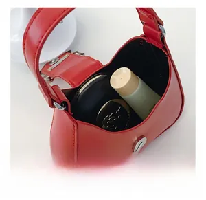 Detailed interior view of a red mini leather bag showing capacity for cosmetics