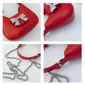 Detail view of red crescent bag showing silver bow and metallic chain strap accents