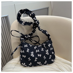 Summer designer canvas handbag with black and white bow print and ruffled shoulder strap