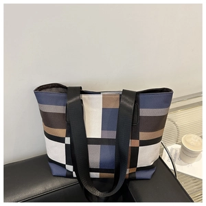 Détail du grand sac cabas avec motif patchwork géométrique sur fond de cuir noir
