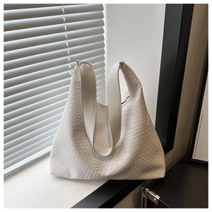 Detailed close-up of white woven texture and sturdy shoulder straps on a large tote bag