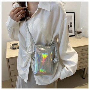Close-up of holographic silver mini crossbody phone bag with knot tassel detail