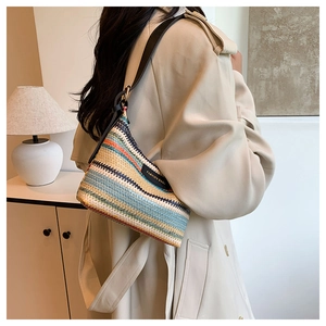 Detailed view of rainbow striped woven shoulder bag with FASHION BAGS label on the side
