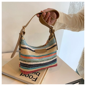 Detail of colorful rainbow striped woven shoulder bag with brown leather strap and logo