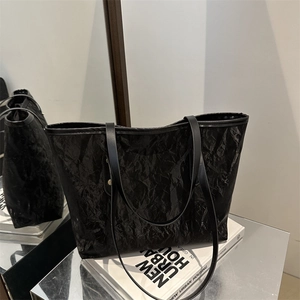 Large black pleated tote bag for women with modern textured finish and slim shoulder straps