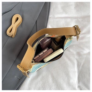 Detail of colorful woven shoulder bag with daily essentials inside showing capacity