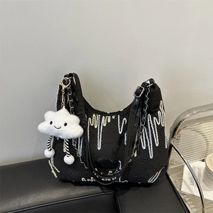 Black textured canvas tote with colorful embroidery and a cute cloud plush charm