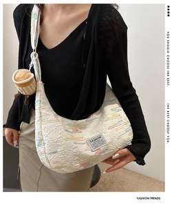 Detail of white nylon crossbody bag with colorful embroidery and coffee cup plush charm