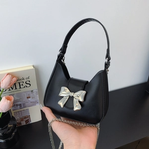 Mini black leather crescent handbag with silver bow detail and metal chain strap